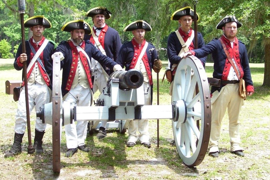 Actors at Fort Morris posing with a cannon